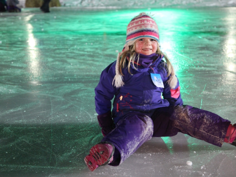 Young girl sits on ice at Jack Frost Festival